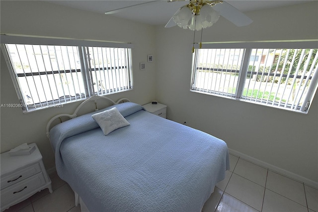 tiled bedroom with ceiling fan