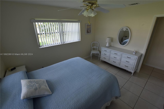 bedroom with ceiling fan and light tile patterned floors