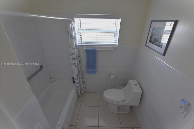 bathroom featuring toilet, tile walls, tile patterned floors, and shower / tub combo with curtain