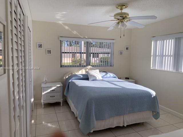 bedroom featuring light tile patterned flooring and ceiling fan