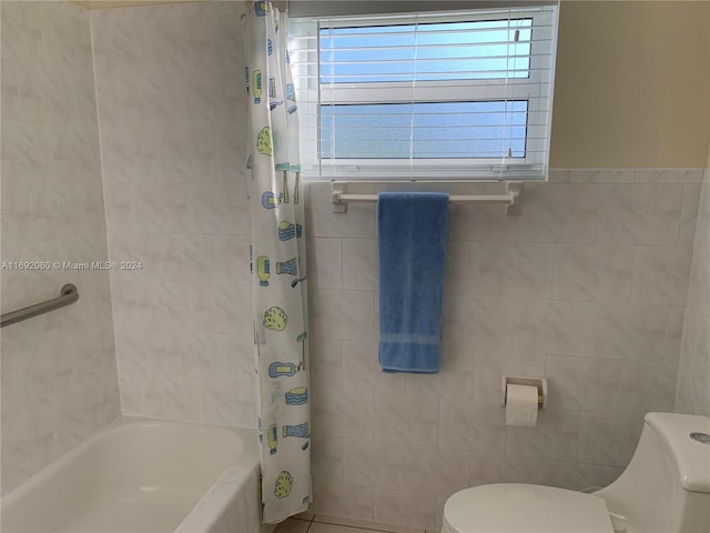 bathroom featuring shower / bath combo, tile walls, and toilet