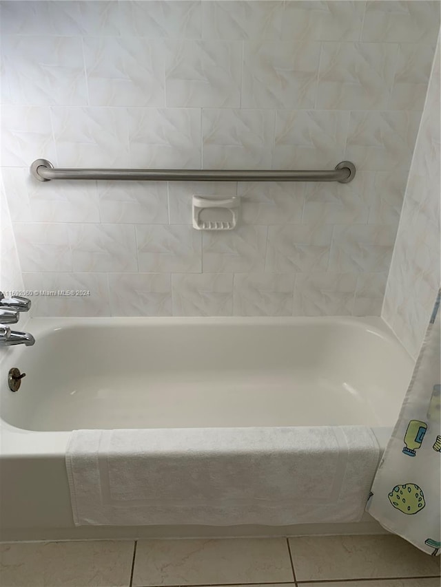 bathroom featuring a tub to relax in and tile patterned floors