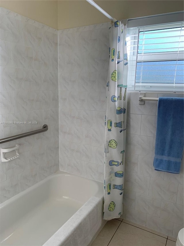 bathroom with shower / bath combination with curtain and tile patterned floors