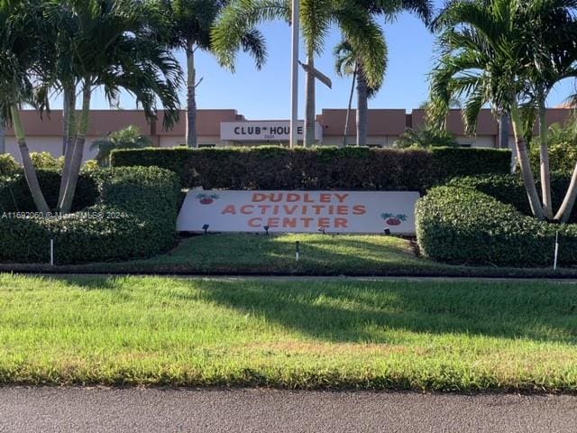 community / neighborhood sign with a lawn