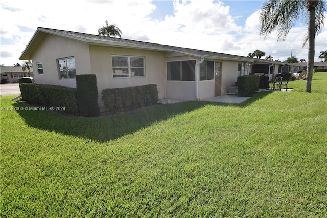 view of side of property with a lawn