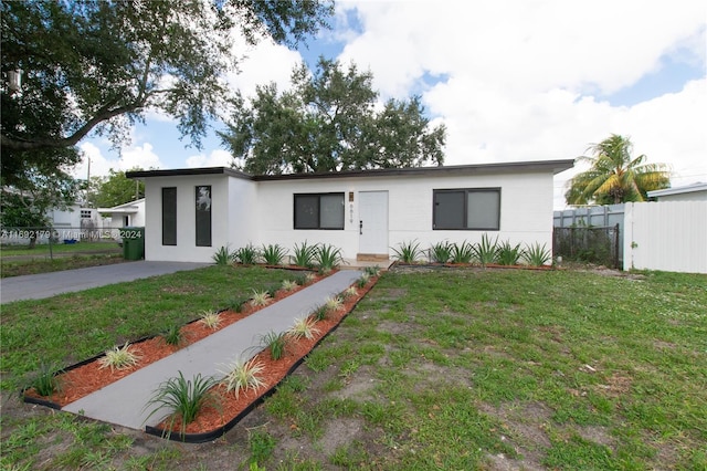 ranch-style house with a front lawn