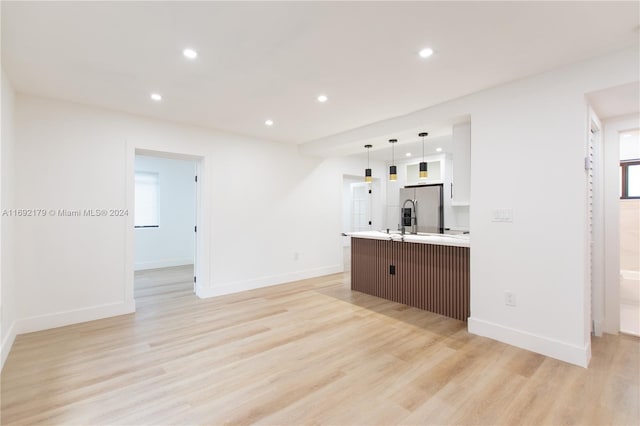 unfurnished living room with light wood-type flooring