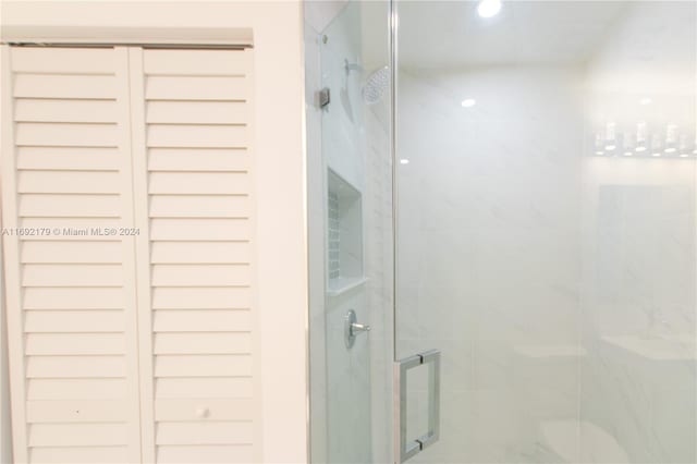 bathroom featuring a shower with door