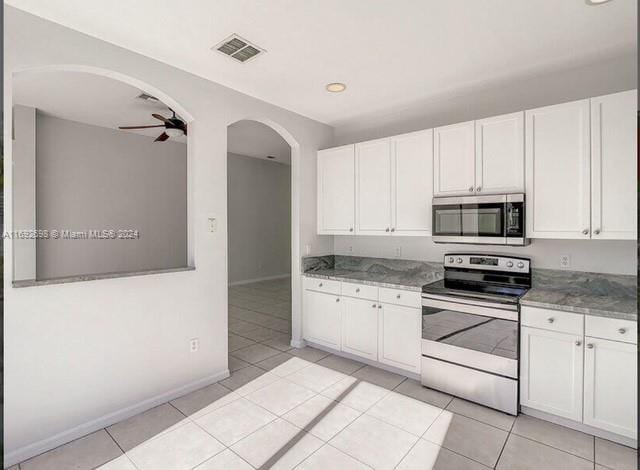 kitchen with white cabinetry, light tile patterned floors, ceiling fan, and stainless steel appliances