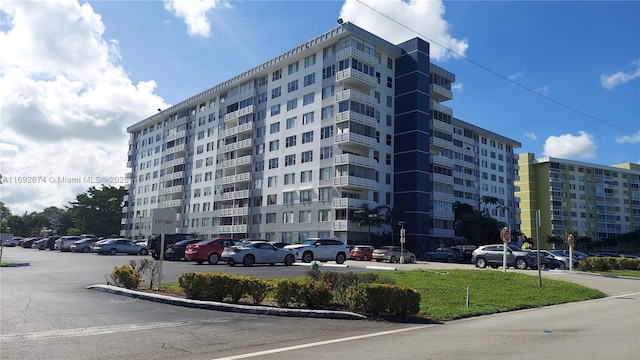 view of building exterior featuring uncovered parking