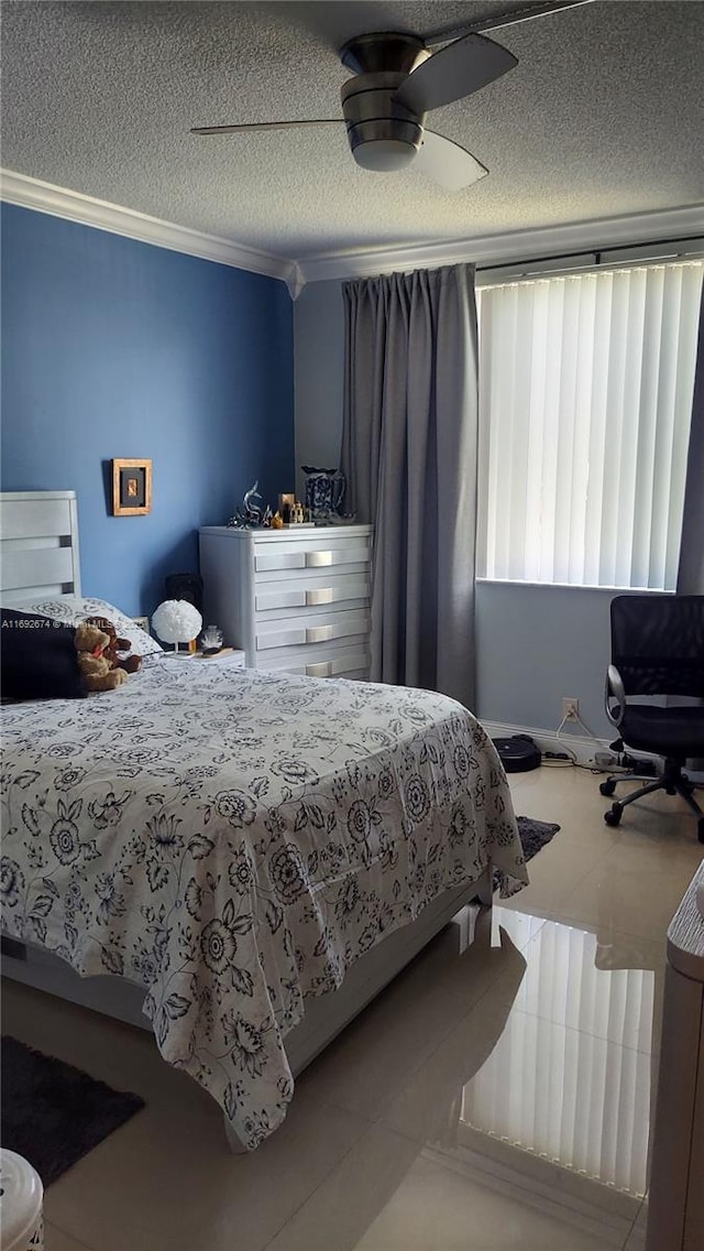 tiled bedroom featuring a textured ceiling, a ceiling fan, and crown molding