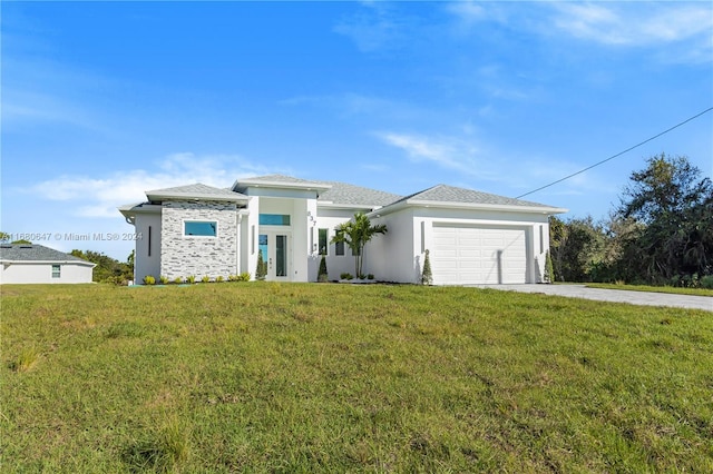 view of front of house featuring a garage and a front yard