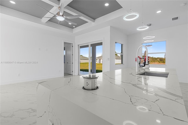 interior space with ceiling fan, a healthy amount of sunlight, sink, and coffered ceiling