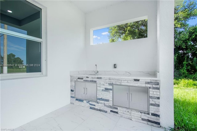 view of patio with an outdoor kitchen and sink