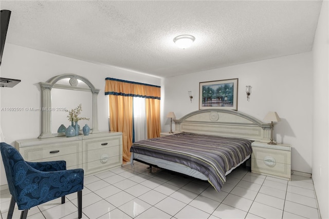 tiled bedroom with a textured ceiling