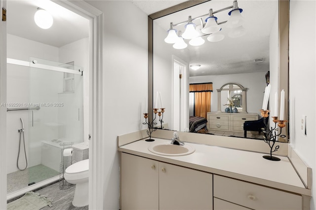 bathroom with walk in shower, vanity, a textured ceiling, and toilet