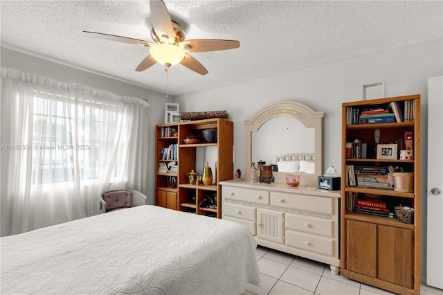 tiled bedroom featuring a textured ceiling and ceiling fan