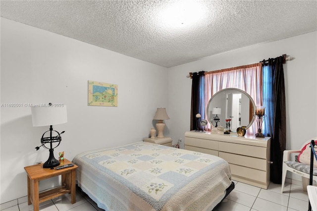 bedroom featuring a textured ceiling and light tile patterned flooring