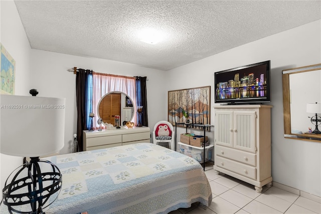 tiled bedroom featuring a textured ceiling