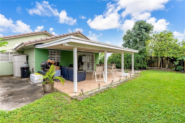 rear view of property with a patio area and a lawn