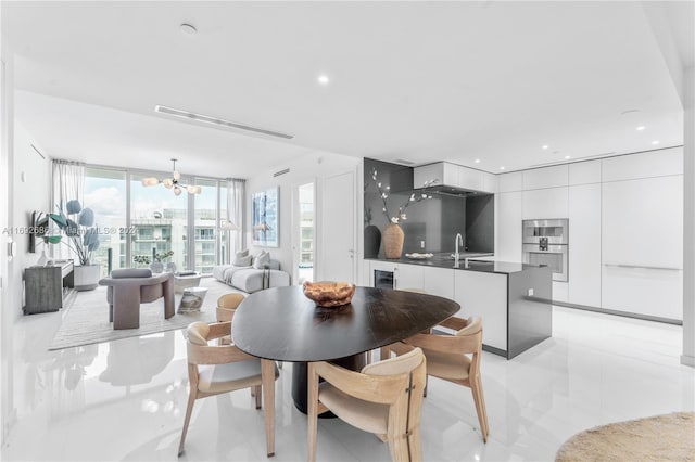 tiled dining area with a notable chandelier and sink