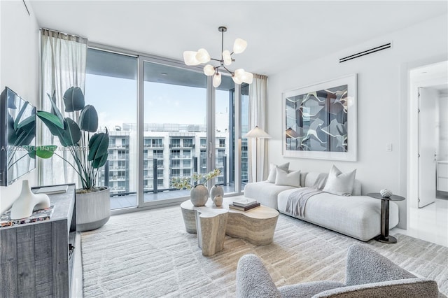 living room featuring a chandelier and a wall of windows