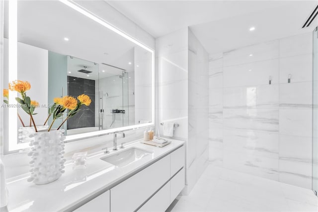 bathroom featuring vanity and a shower with shower door