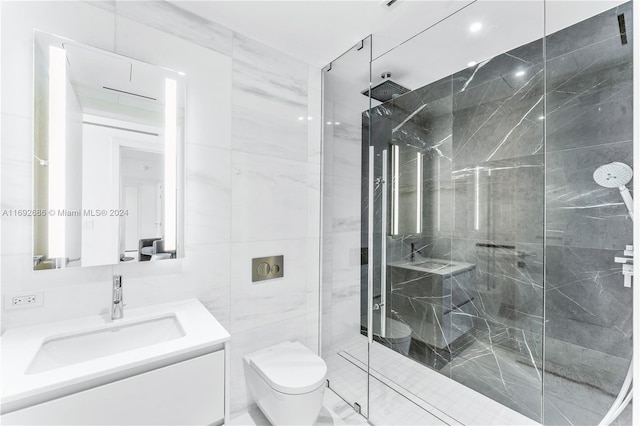 bathroom featuring a shower with shower door, vanity, toilet, and tile walls