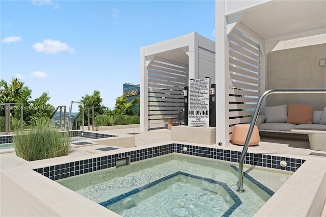 view of pool with a hot tub