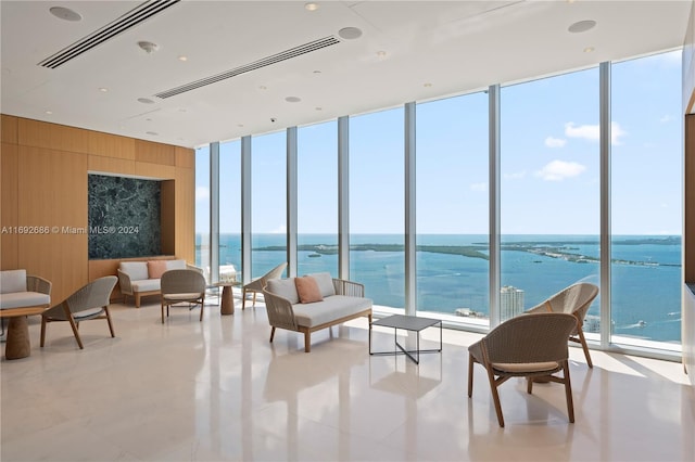 sunroom / solarium featuring plenty of natural light and a water view