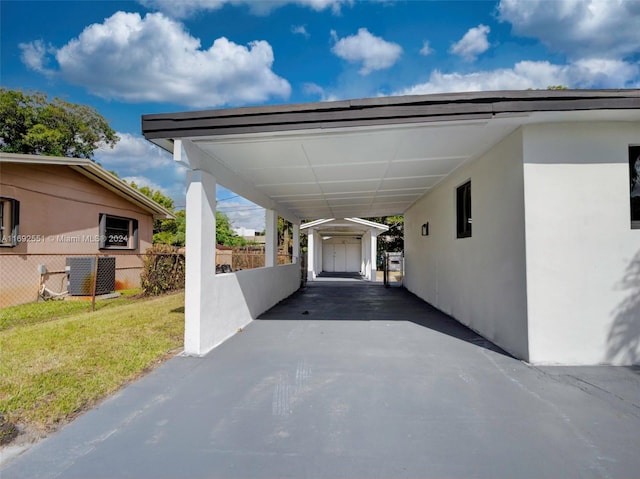 view of car parking with a yard and a carport