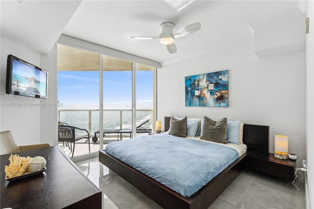 bedroom featuring light tile patterned floors, access to exterior, expansive windows, a water view, and ceiling fan