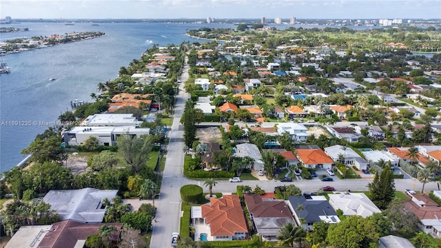 drone / aerial view featuring a water view and a residential view