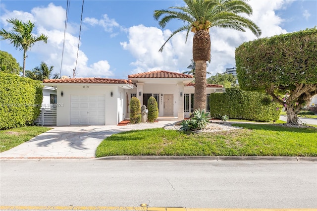 mediterranean / spanish-style home with a garage