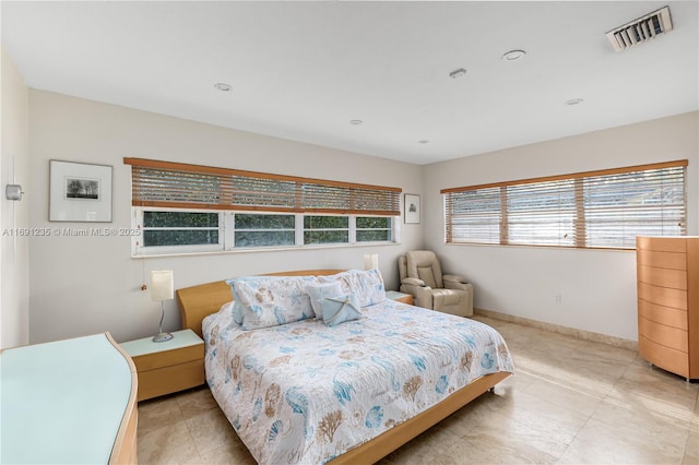 bedroom featuring light tile patterned flooring, baseboards, and visible vents