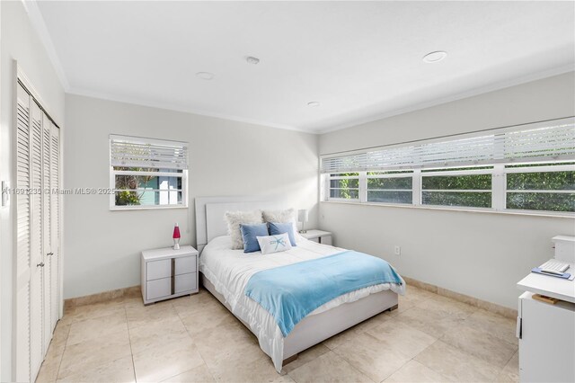 8801 Dickens Ave, Surfside, FL 33154 - bedroom featuring ornamental molding, baseboards, light tile patterned floors, and a closet