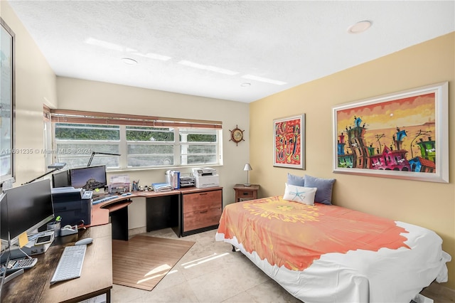 tiled bedroom with a textured ceiling and multiple windows