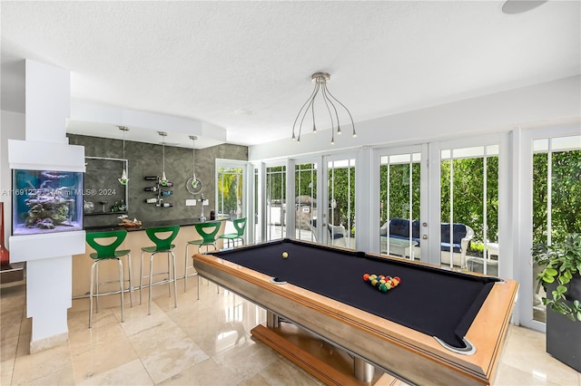 game room featuring french doors, a textured ceiling, and billiards