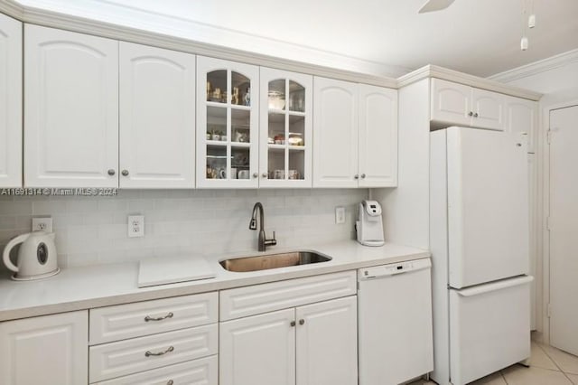 kitchen featuring white cabinets, sink, light tile patterned flooring, crown molding, and white appliances