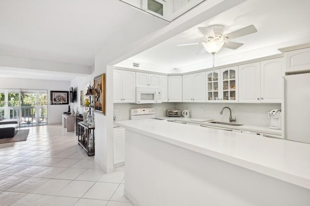 kitchen featuring white appliances, sink, ceiling fan, and white cabinets