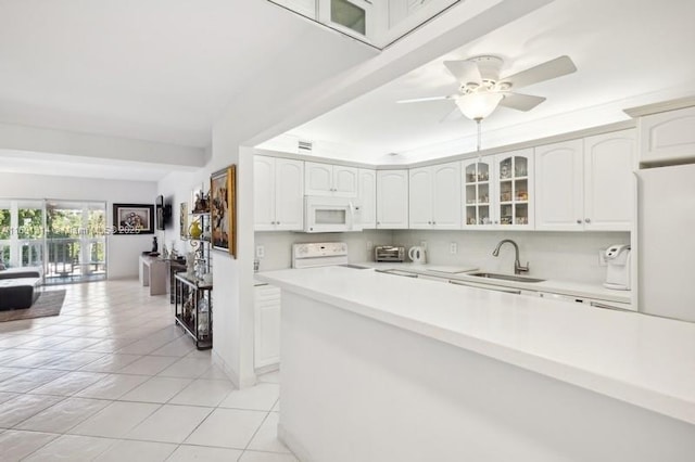 9111 E Bay Harbor Dr Unit 3E, Bay Harbor Islands, FL 33154 - kitchen featuring white microwave, range, glass insert cabinets, light tile patterned floors, and light countertops