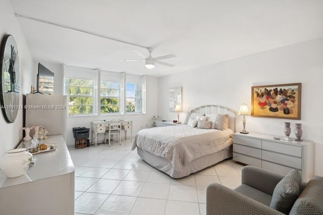 tiled bedroom featuring ceiling fan