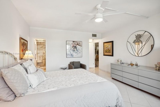 bedroom featuring light tile patterned floors, ceiling fan, and connected bathroom