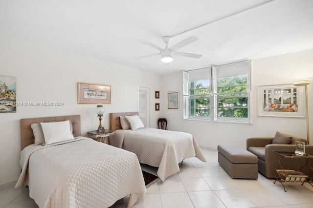 tiled bedroom with ceiling fan