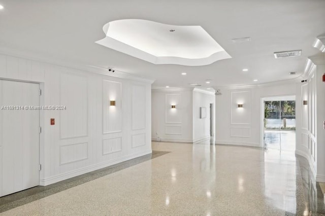 interior space featuring a tray ceiling and crown molding