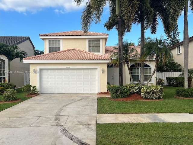 mediterranean / spanish house with a garage and a front yard