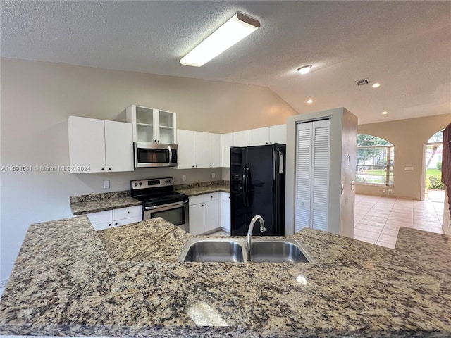 kitchen featuring stainless steel appliances, vaulted ceiling, white cabinets, kitchen peninsula, and sink