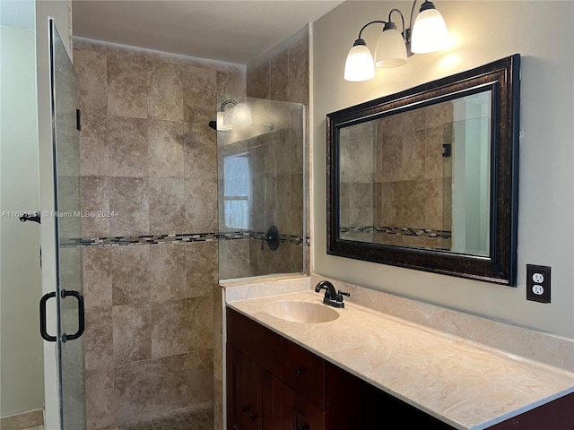 bathroom featuring an enclosed shower and vanity