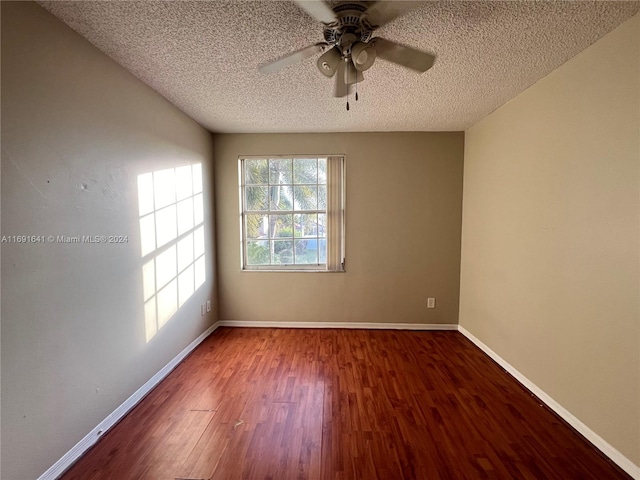 empty room with a textured ceiling, hardwood / wood-style floors, and ceiling fan