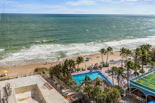 birds eye view of property with a view of the beach and a water view